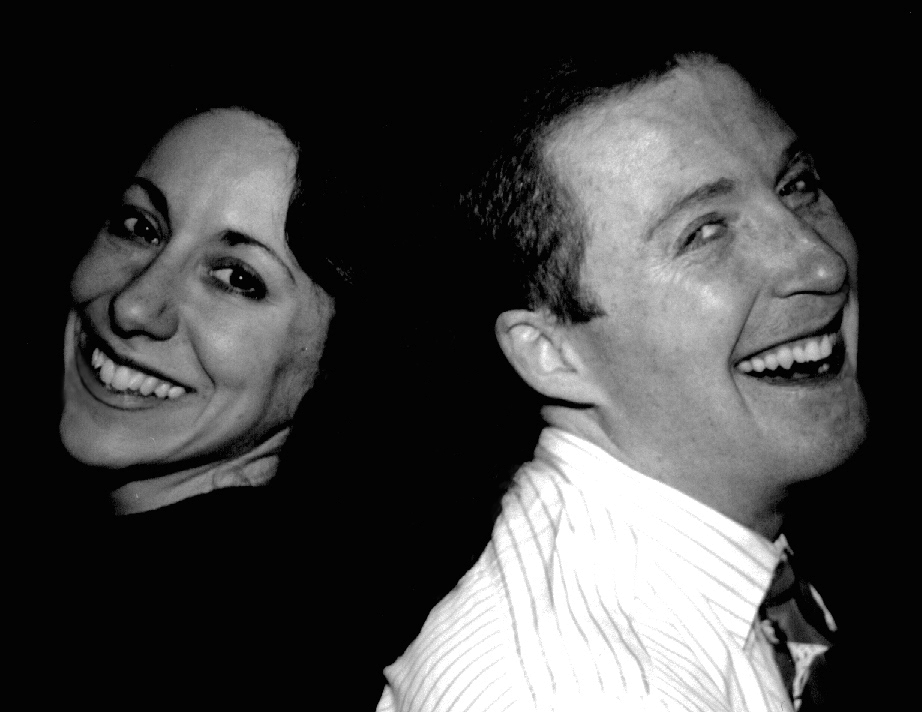 Lillian Rozin and Will McMillan standing back to back and smiling...